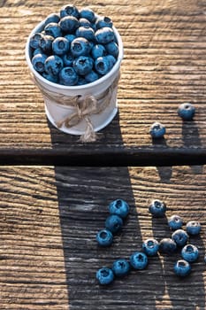 Some blueberries in a decorate small bucket on wooden banch in the garden on summer sunset, healthy food concept