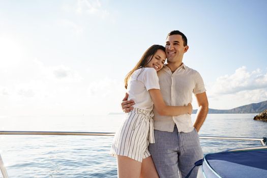 Happy couple in love on a yacht in summer on romantic vacation