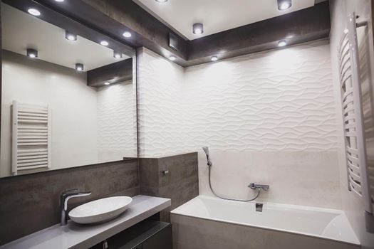 Modern bathroom in white and gray tones with mosaic on wide angle view. Real estate concept.