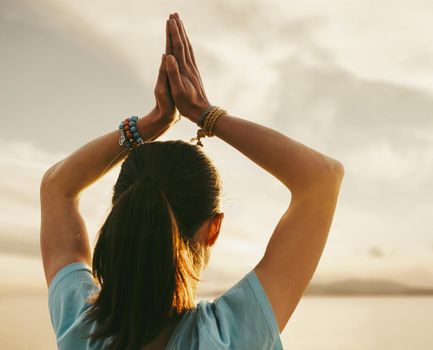 Woman practicing yoga with praying gesture.