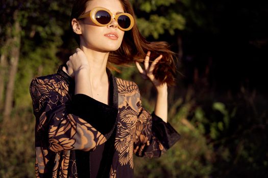 pretty woman wearing sunglasses outdoors fashion nature. High quality photo