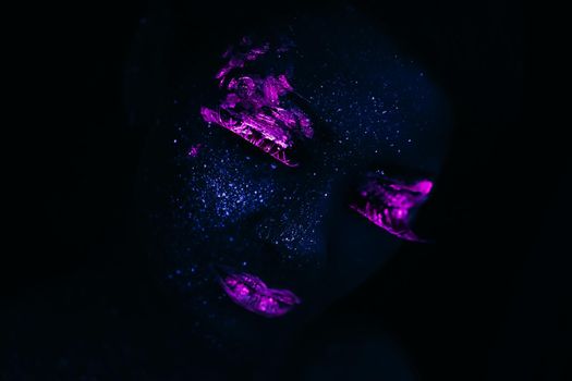 Portrait of Beautiful Fashion Woman in Neon UF Light. Model Girl with Fluorescent Creative Psychedelic MakeUp, Art Design of Female Model in UV, Colorful Abstract Make-Up