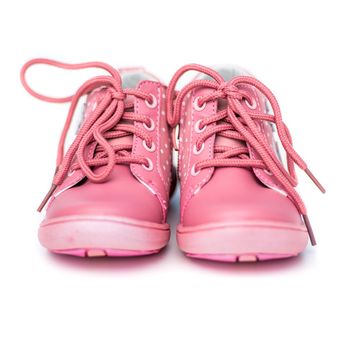 new pink shoes for a baby white background