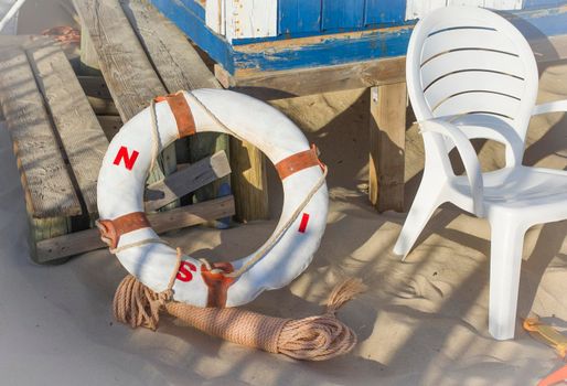 Life guard and ropes near wood lifeguard tower