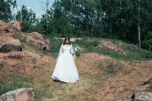 Wedding photography in rustic style emotions of the bride on the nature on the rocks