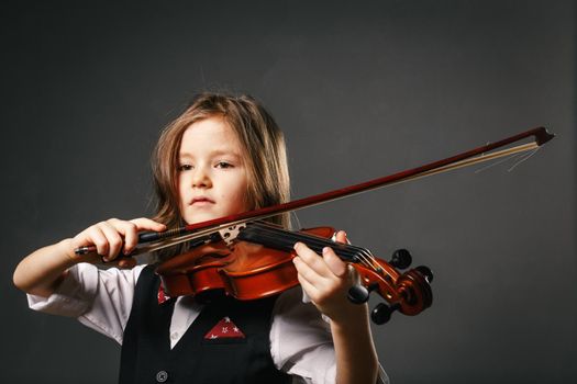 Beautiful girl with long hair playing violin