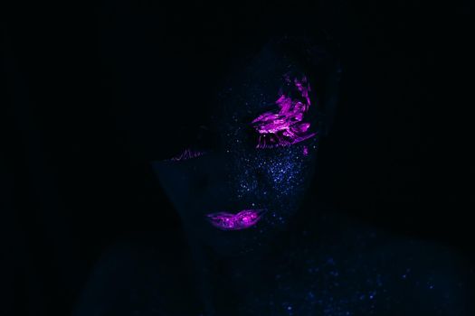 Portrait of Beautiful Fashion Woman in Neon UF Light. Model Girl with Fluorescent Creative Psychedelic MakeUp, Art Design of Female Model in UV, Colorful Abstract Make-Up