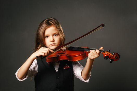Beautiful girl with long hair playing violin