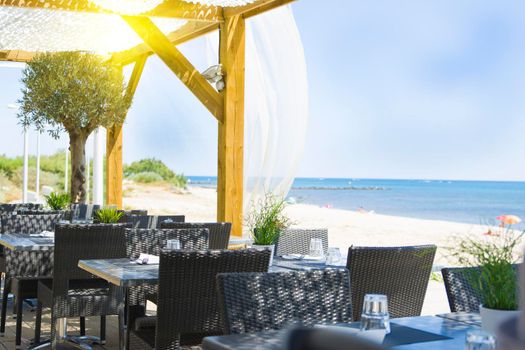 table and chairs in the restaurant on the blue sea background