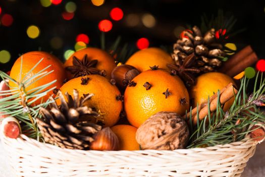 Christmas basket - fir, tangerins and spices on the snow