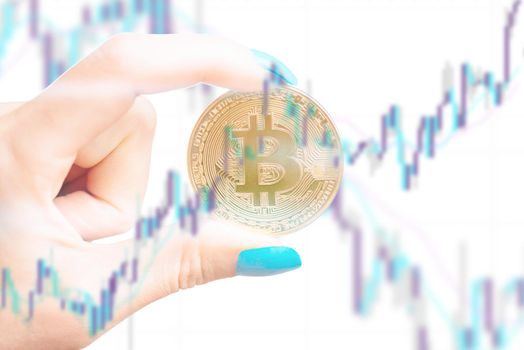 Multiexposure of female hand with symbol of cryptocurrency - bitcoin with diagram.