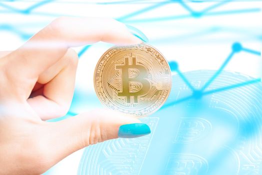 Female hand holding symbol of cryptocurrency - one bitcoin on background of blockchain scheme.