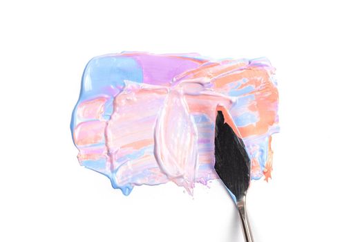 a painting palette knife isolated on a white background painting a pink and violet with copy space