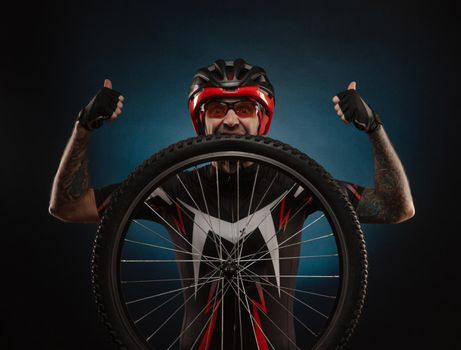 guy-cyclist in a Bicycle helmet with a Bicycle wheel