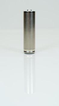 AA alkaline rechargeable battery on white glossy background with reflection. Close one empty battery with copy space. Vertical photography