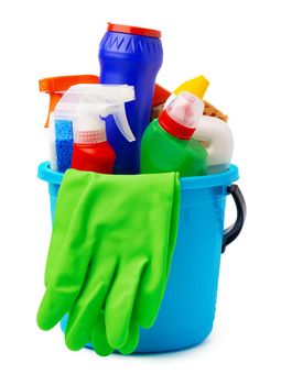 Liquid detergents and cleaning supplies in plastic bucket on white background, close up