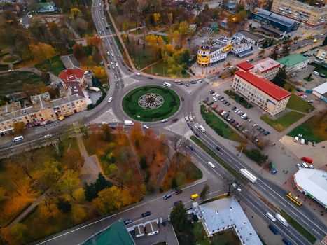 Aerial view of roundabout road with circular cars in small european city at autumn cloudy day, Kyiv region, Ukraine