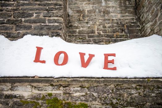 Red Love Letters at the Snow. Message red love letters on white snow. word love on white background about-valentine friends or lovers day