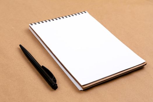 Stationary concept, Flat Lay top view Photo of pencil and notepad on a beige abstract background with copy space, minimal style