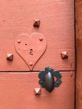 Close up of ancient door with lock- keyhole with a heart