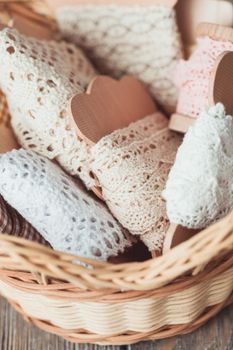 Vintage lace on the wooden bobbin in a basket