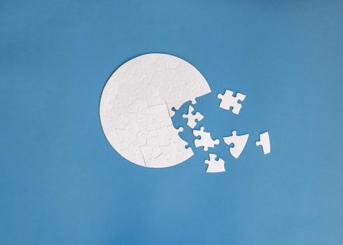 white round shaped jigsaw puzzle on blue background