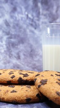 American gluten free chocolate chip cookies with glass glass of vegetable milk on gray background. Chocolate chip cookies. Sweet pastries, dessert. Culinary background. Vertical photography