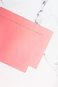 Pink A4 papers on white marble background as office stationery flatlay, luxury branding flat lay and brand identity design for mockups