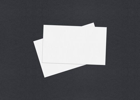 Blank white Business card mockup stacks at grey textured paper background.