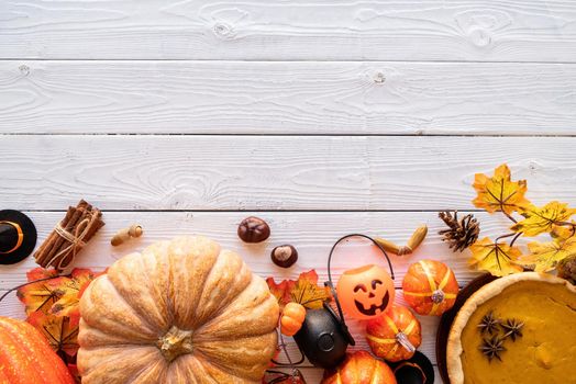 Autumn concept. Homemade pumpkin pie with autumn leaves on rustic background, top view flat lay