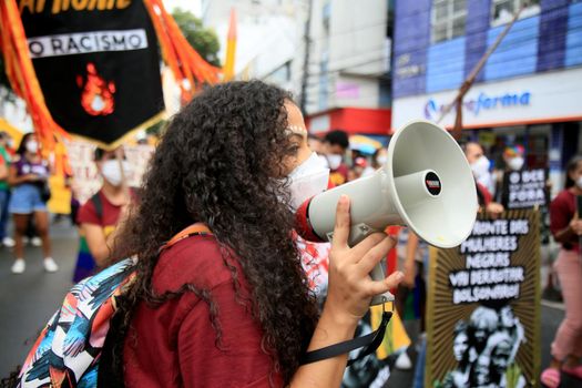 salvador, bahia, brazil - july 24, 2018: Protester uses Brazil megaphone during protest against President Jair Bolsonaro's government in Salvador city.