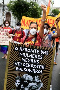 salvador, bahia, brazil - july 24, 2018: Black woman wearing mask during protest against President Jair Bolsonaro's government in the city of Salvador.