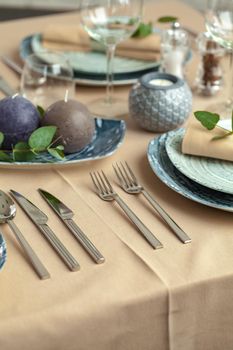 Table setting in restaurant with stylish decorations. Close up.