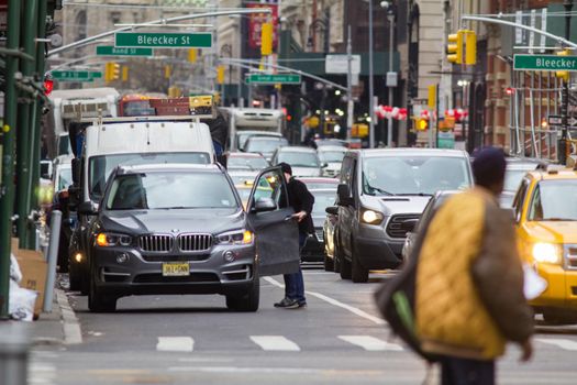 NEW YORK, USA - Decembre 2017: busy road in a big city with lots of cars and people, urban landscape