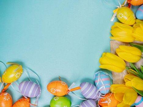 Easter holiday celebration at Coronavirus pandemic. Covid19 protective masks, Easter eggs and tulips on wooden table background