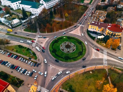 Aerial view of roundabout road with circular cars in small european city at autumn cloudy day, Kyiv region, Ukraine