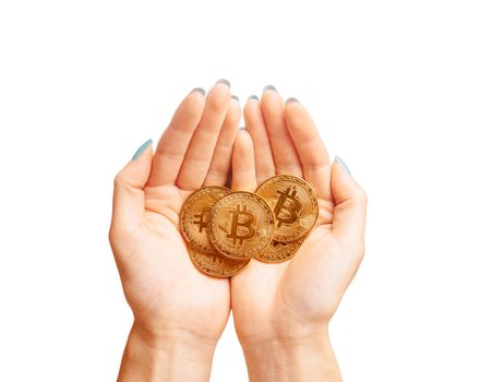 Many gold bitcoins coins in female hands isolated on a white background, top view.