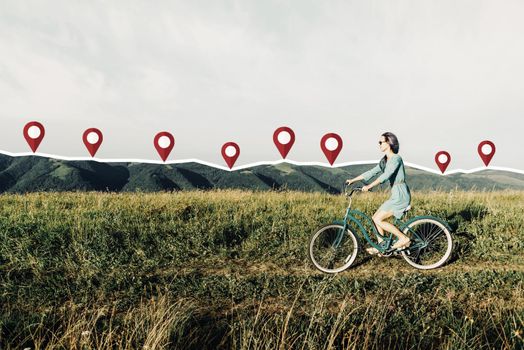 Beautiful young woman in dress riding bicycle on summer meadow with connected location pins and track. Navigation concept.