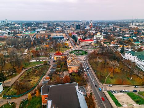 Aerial view of roundabout road with circular cars in small european city at autumn cloudy day, Kyiv region, Ukraine