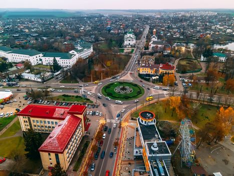 Aerial view of roundabout road with circular cars in small european city at autumn cloudy day, Kyiv region, Ukraine