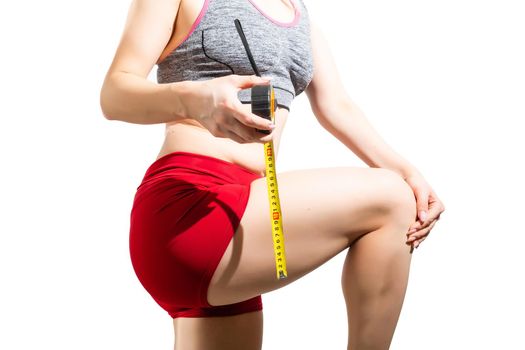 Woman measures her hip. Weight loss concept, isolated, over white background.