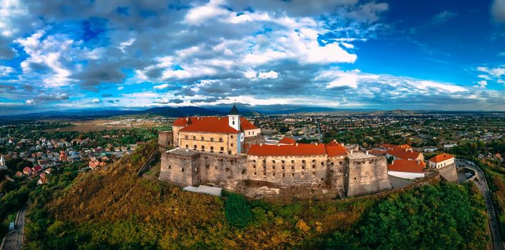 Aerial view of medieval castle on mountain in small european city in autumn season. Panorama of Palanok castle, Mukachevo, Ukraine