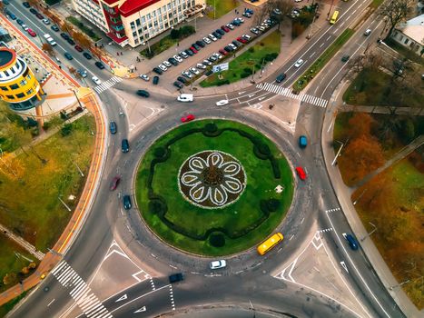 Aerial view of roundabout road with circular cars in small european city at autumn cloudy day, Kyiv region, Ukraine