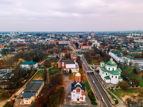 Aerial view of two old churches near river and bridge in small european city at summer day, Kyiv region, Ukraine