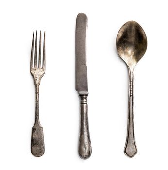 old metal fork with knife and spoon isolated on a white background