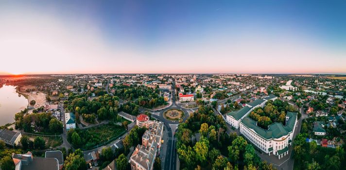 Aerial panoramic view of roundabout road with circular cars in small european city at cloudy autumn day, Kyiv region, Ukraine