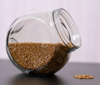 Healthy food buckwheat in a glass jar is on the table