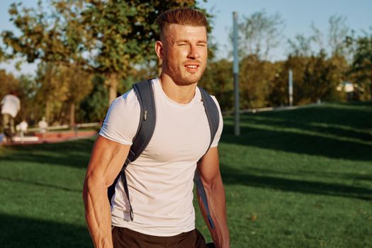 sportive man workout in the park morning motivation. High quality photo