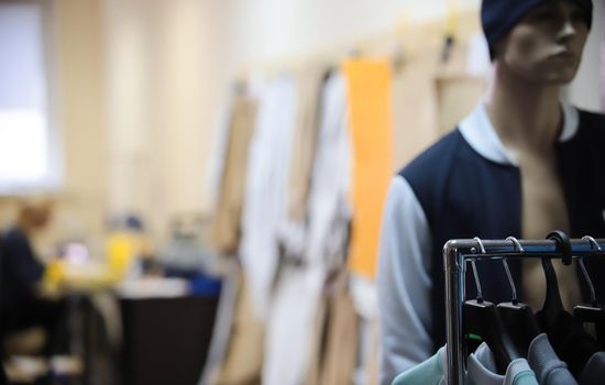Clothing industry. Office. Mannequin in the frame. Hangers in focus