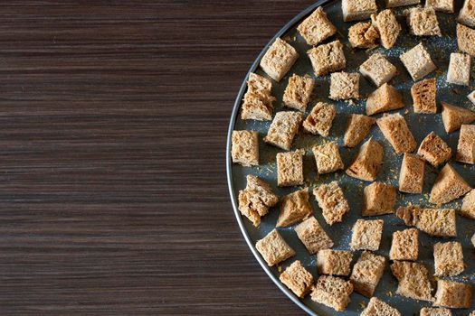 Crackers on a baking sheet on a dark background